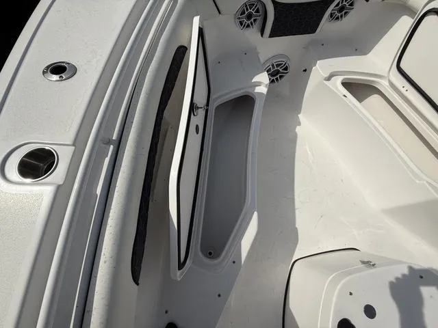 Slide: The Image of 2024 Tidewater 256 CC Adventure boat interior with open storage compartments. - 49