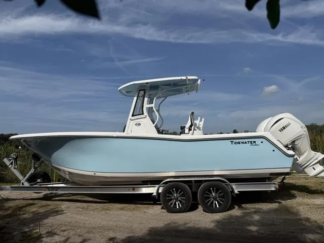 Slide: The Image of 2024 Tidewater 256 CC Adventure boat on trailer, side view, outdoors. - 9