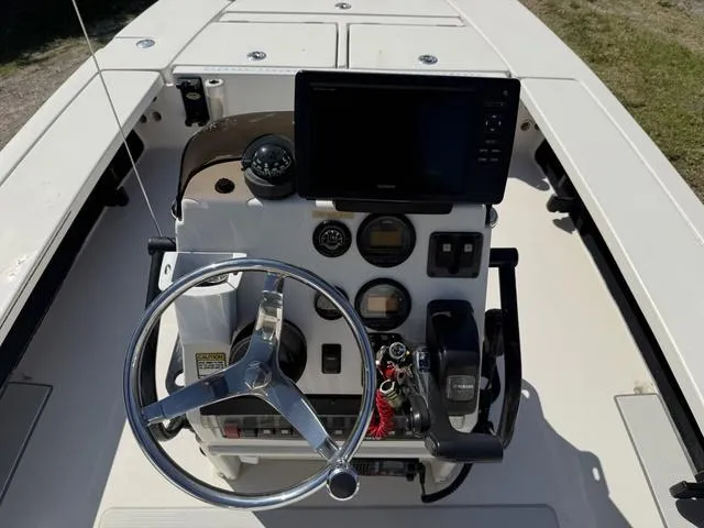 Slide: The Image of 2009 Hewes 18 Redfisher boat console with steering wheel and navigation equipment. - 13