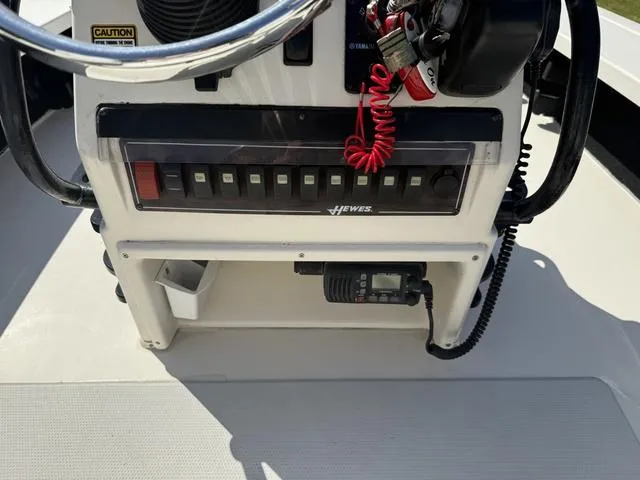 Slide: The Image of 2009 Hewes 18 Redfisher boat console with control panel and steering wheel. - 14