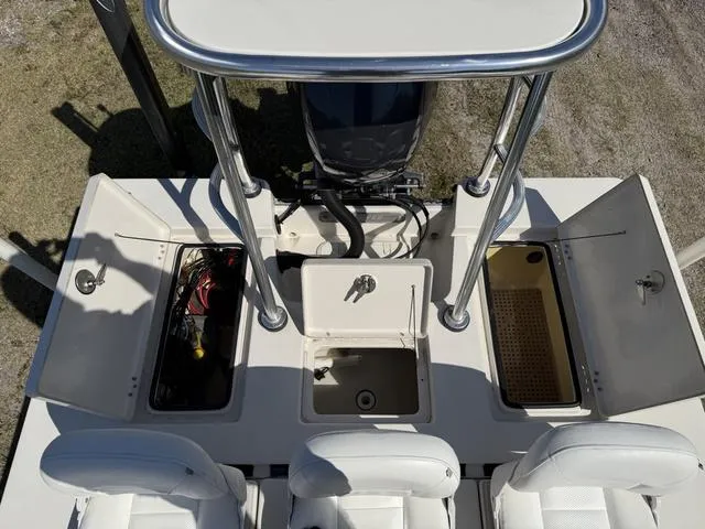 Slide: The Image of 2009 Hewes 18 Redfisher boat interior with storage compartments and seating. - 19