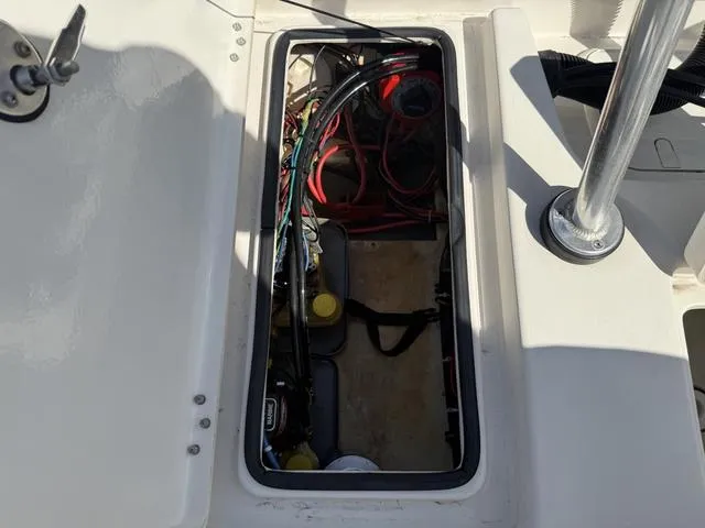 Slide: The Image of 2009 Hewes 18 Redfisher boat compartment with wiring and battery components visible. - 20