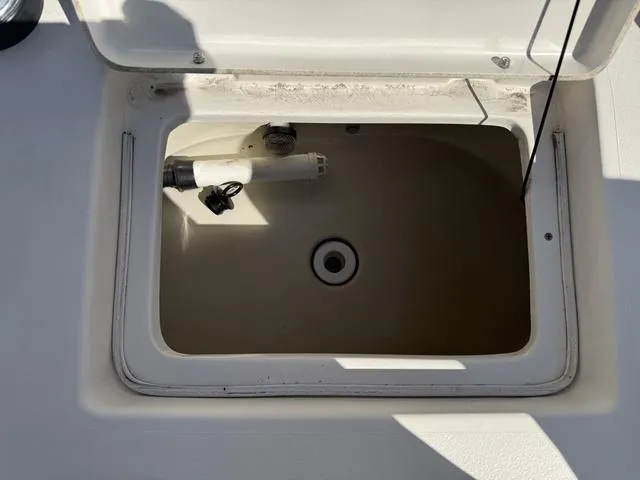 Slide: The Image of Open storage compartment on a 2009 Hewes 18 Redfisher boat. - 21