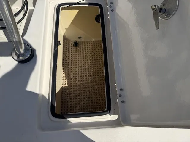 Slide: The Image of Open hatch on 2009 Hewes 18 Redfisher boat, showing interior compartment. - 22