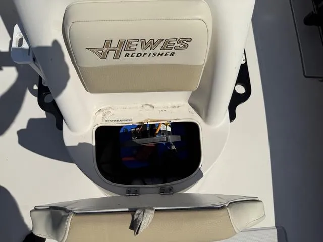 Slide: The Image of 2009 Hewes 18 Redfisher boat seat with storage compartment open. - 24
