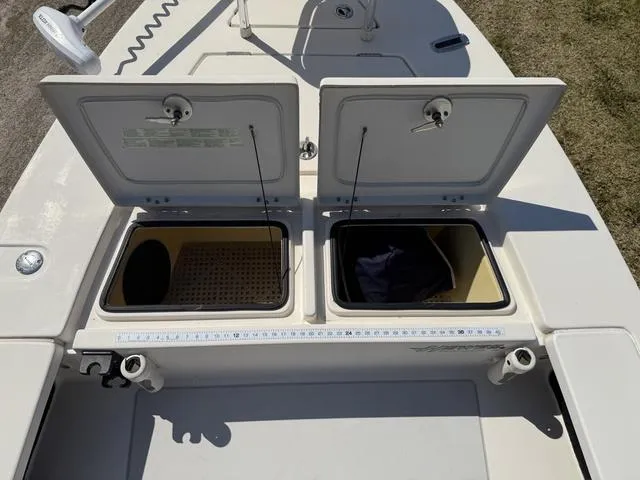 Slide: The Image of 2009 Hewes 18 Redfisher boat with open storage compartments and fishing rod holders. - 25