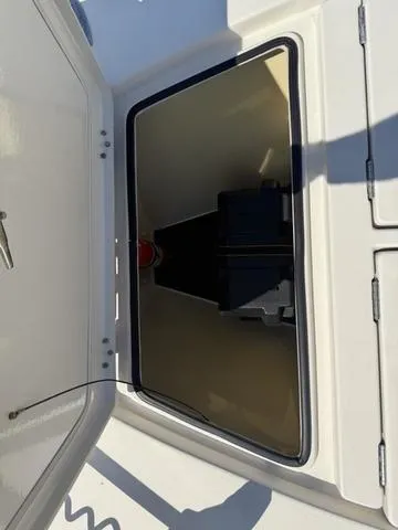 Slide: The Image of Open storage compartment on 2009 Hewes 18 Redfisher boat. - 28