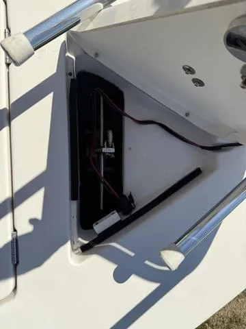 Slide: The Image of 2009 Hewes 18 Redfisher boat compartment with wiring and components visible. - 29