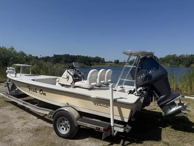 Slide: The Image of 2009 Hewes 18 Redfisher boat with Yamaha engine on trailer by a lake. - 3