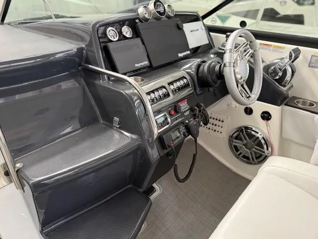 Slide: The Image of 2020 Formula 350 Sun Sport boat cockpit with modern controls and steering wheel. - 16