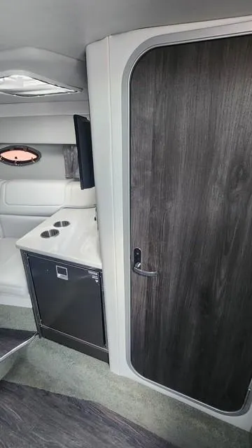 Slide: The Image of 2020 Formula 350 Sun Sport cabin interior with sleek wood finish and compact kitchenette. - 33