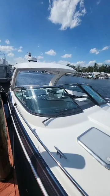 Slide: The Image of 2020 Formula 350 Sun Sport boat docked under a clear blue sky. - 35