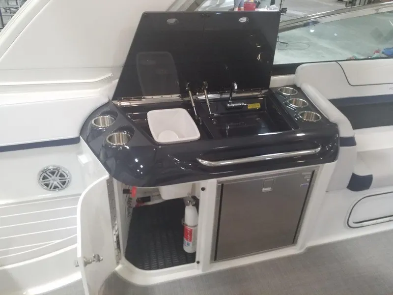 Slide: The Image of 2020 Formula 350 Sun Sport boat kitchenette with sink, storage, and fire extinguisher. - 38