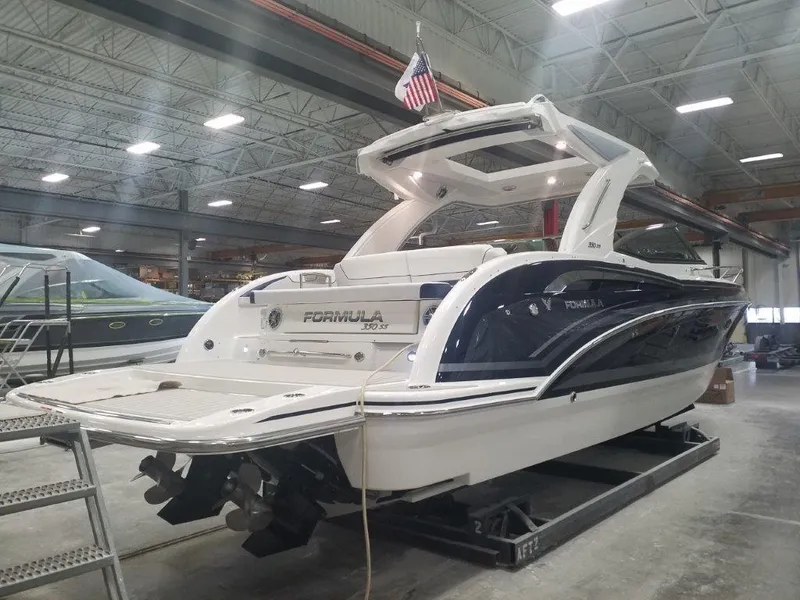 Slide: The Image of 2020 Formula 350 Sun Sport boat in a warehouse, showcasing sleek design and modern features. - 4