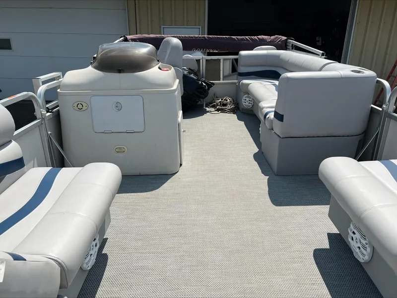 Slide: The Image of 2003 Manitou Osprey pontoon boat interior with gray seating and carpeted floor. - 11