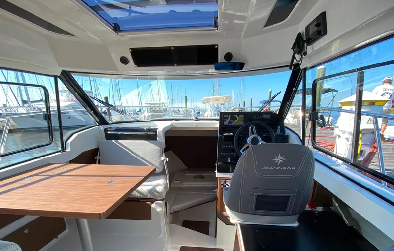 Slide: The Image of Interior of 2021 Jeanneau NC795 S2 boat with helm, seating, and table. - 9