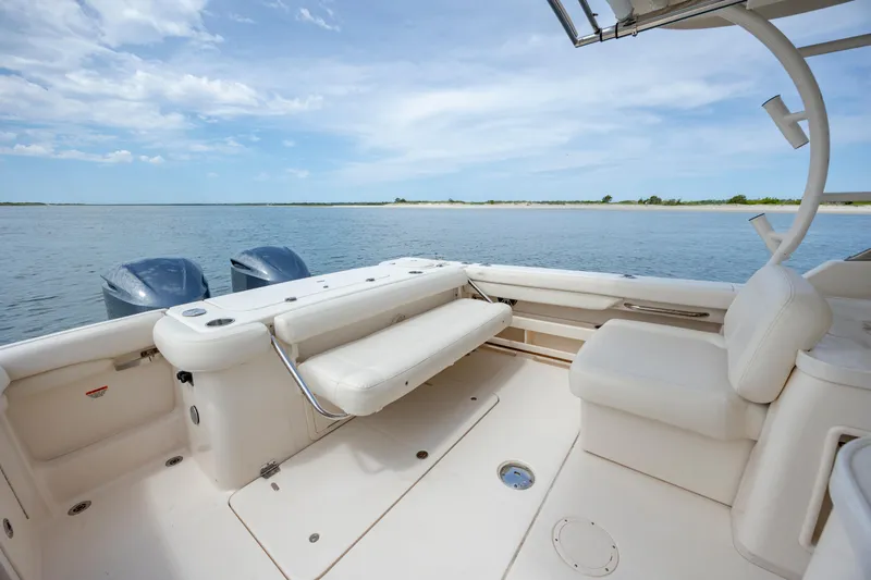 Slide: The Image of 2020 Grady-White Freedom 307 boat interior with seating, overlooking calm waters. - 11