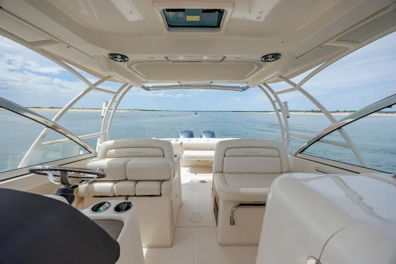 Slide: The Image of 2020 Grady-White Freedom 307 boat interior with ocean view, featuring comfortable seating and modern design. - 18