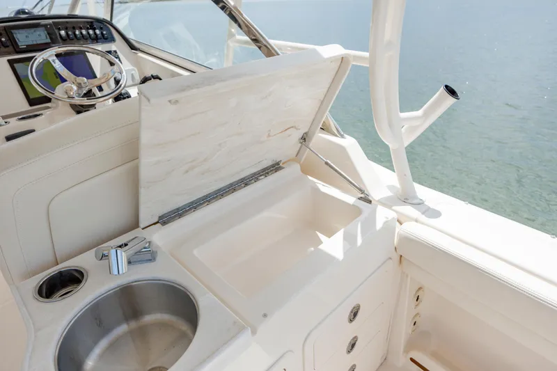 Slide: The Image of 2020 Grady-White Freedom 307 boat interior with sink and storage compartment. - 25