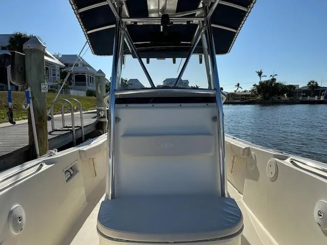 Slide: The Image of 2005 Pursuit 2570 Center Console boat docked by waterfront homes. - 11