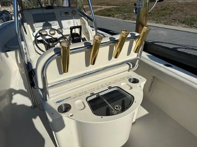 Slide: The Image of 2005 Pursuit 2570 Center Console boat interior with rod holders and steering wheel. - 3