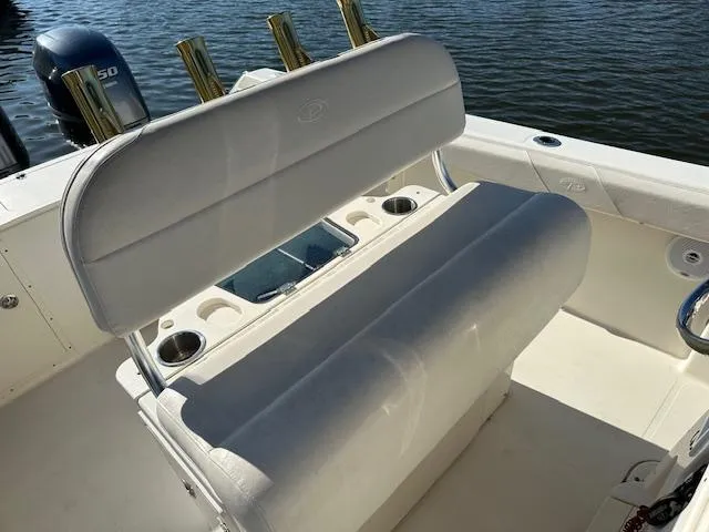 Slide: The Image of 2005 Pursuit 2570 Center Console boat interior with seating and rod holders. - 5