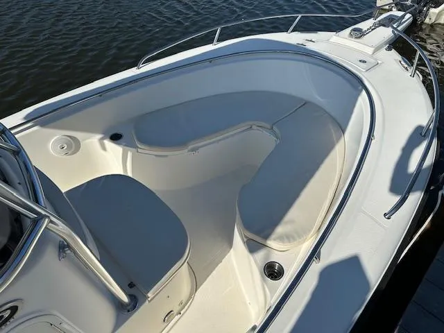Slide: The Image of 2005 Pursuit 2570 Center Console boat with spacious seating area and stainless steel railings. - 8