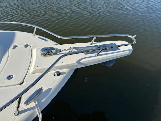 Slide: The Image of 2005 Pursuit 2570 Center Console boat bow with anchor, on calm water. - 9