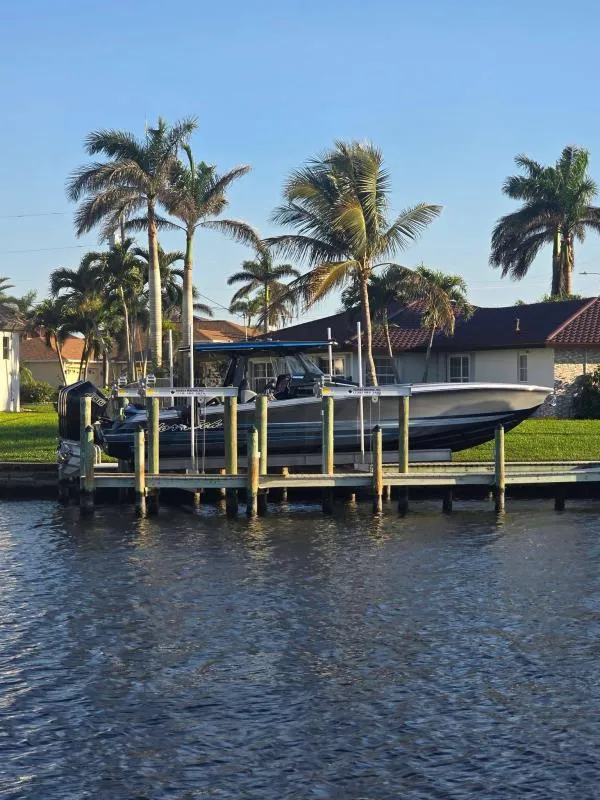 Slide: The Image of 2025 Nor-Tech 400 Supersport docked by palm trees, waterfront view. - 5