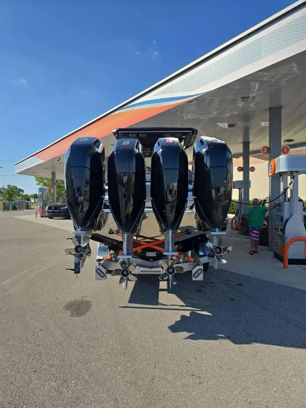 Slide: The Image of 2025 Nor-Tech 400 Supersport with five powerful outboard engines at a gas station. - 6