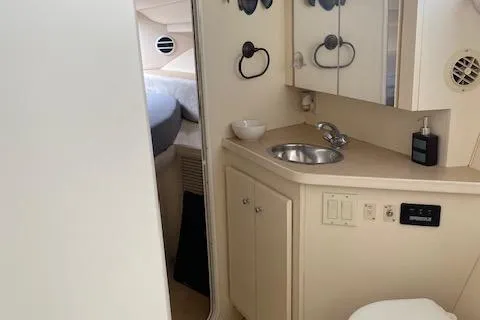 Slide: The Image of 1998 Carver 380 Santego yacht interior with compact bathroom and sink. - 13
