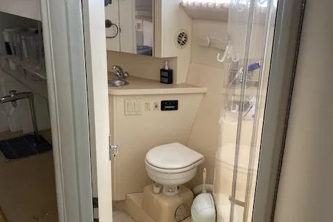 Slide: The Image of Bathroom interior of 1998 Carver 380 Santego yacht, featuring toilet and sink. - 14
