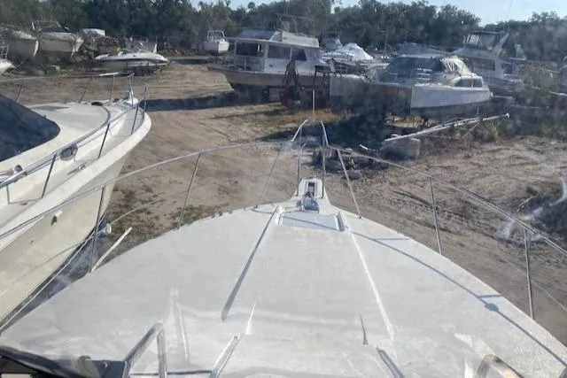 Slide: The Image of 1998 Carver 380 Santego yacht in a boatyard with other vessels. - 17