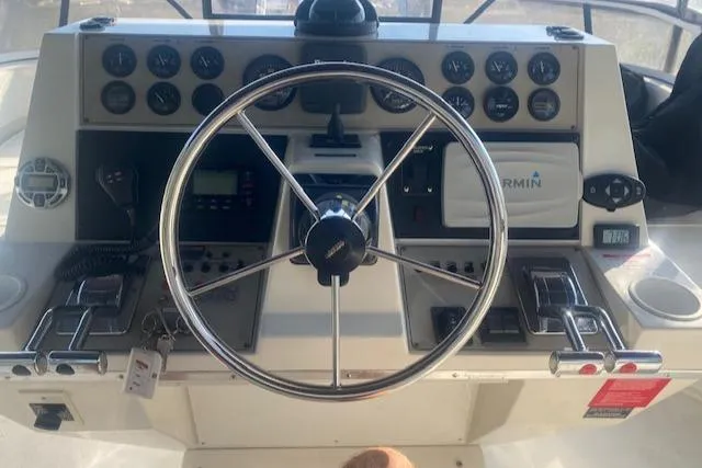 Slide: The Image of 1998 Carver 380 Santego helm with steering wheel, gauges, and Garmin navigation system. - 20