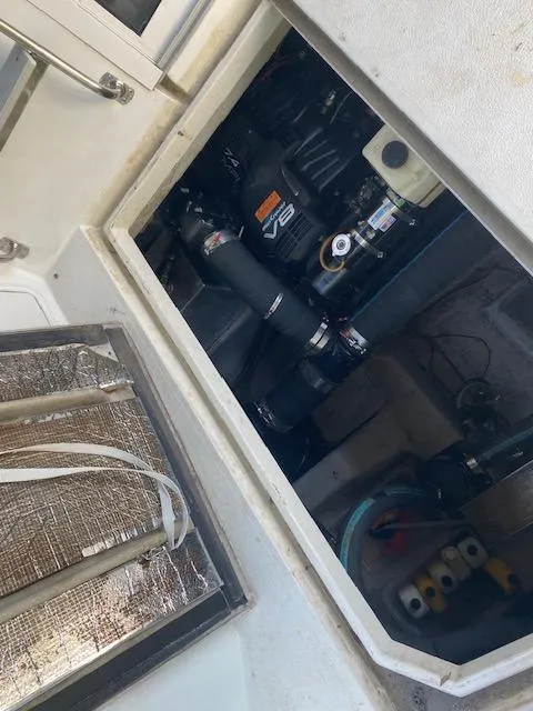 Slide: The Image of Engine compartment of a 1998 Carver 380 Santego boat, featuring a V8 engine. - 22