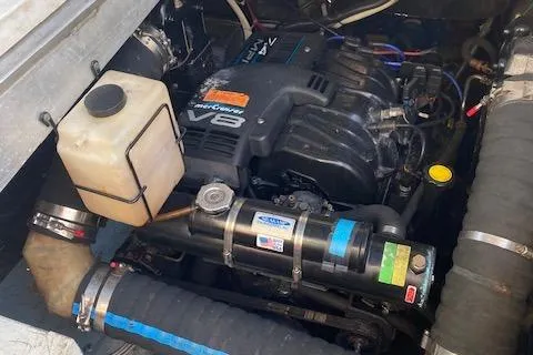 Slide: The Image of Engine compartment of a 1998 Carver 380 Santego boat, featuring a V8 engine. - 23