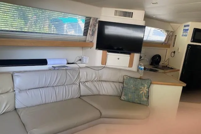 Slide: The Image of Interior of 1998 Carver 380 Santego yacht with leather seating and TV. - 8