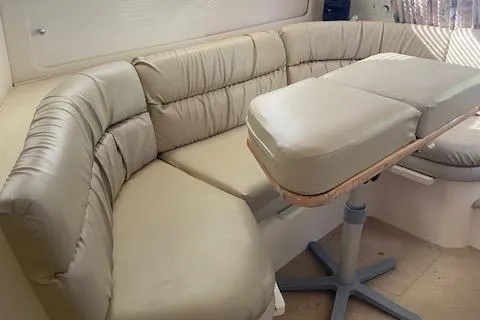 Slide: The Image of 1998 Carver 380 Santego interior with beige leather seating and adjustable table. - 10