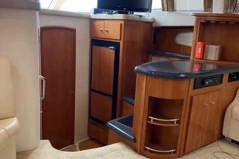 Slide: The Image of Interior of 1998 Carver 380 Santego yacht with wood cabinetry and modern amenities. - 4