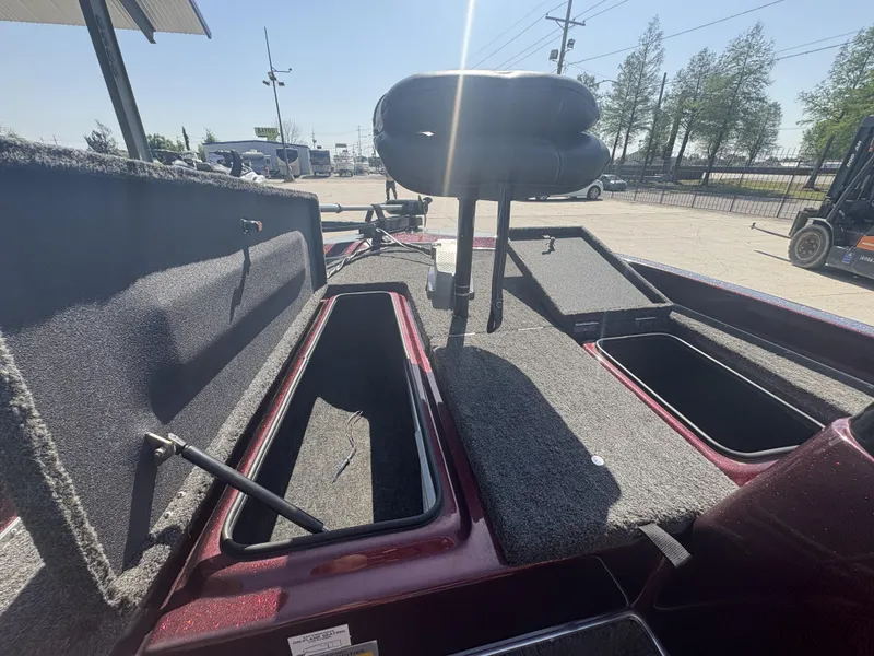 Slide: The Image of 1999 Champion MEAN 16 boat interior with open storage compartments and seating. - 11