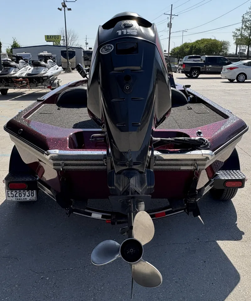 Slide: The Image of 1999 Champion MEAN 16 boat with outboard motor in a parking lot. - 7