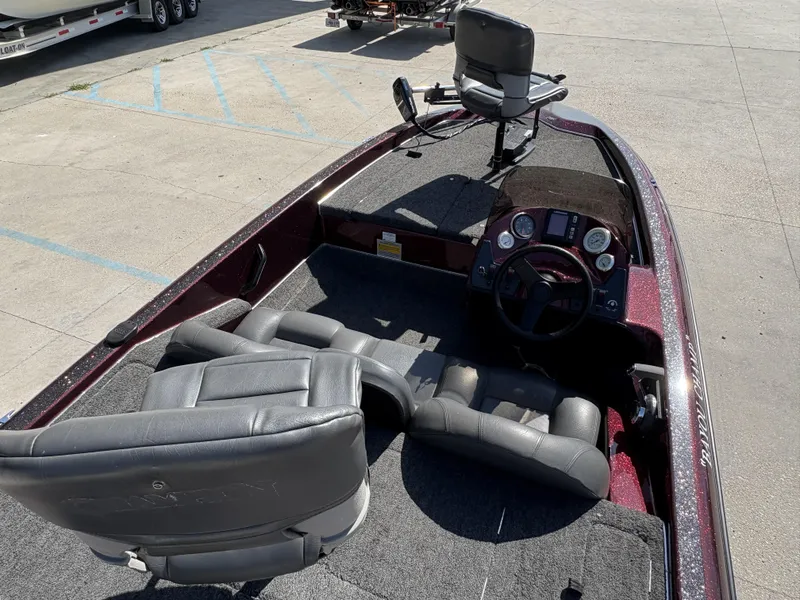 Slide: The Image of 1999 Champion MEAN 16 boat interior with steering console and seating. - 8