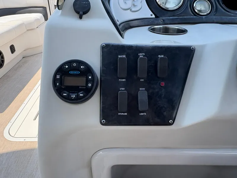 Slide: The Image of Control panel of a 2020 G3 SunCatcher boat with switches and audio system. - 17
