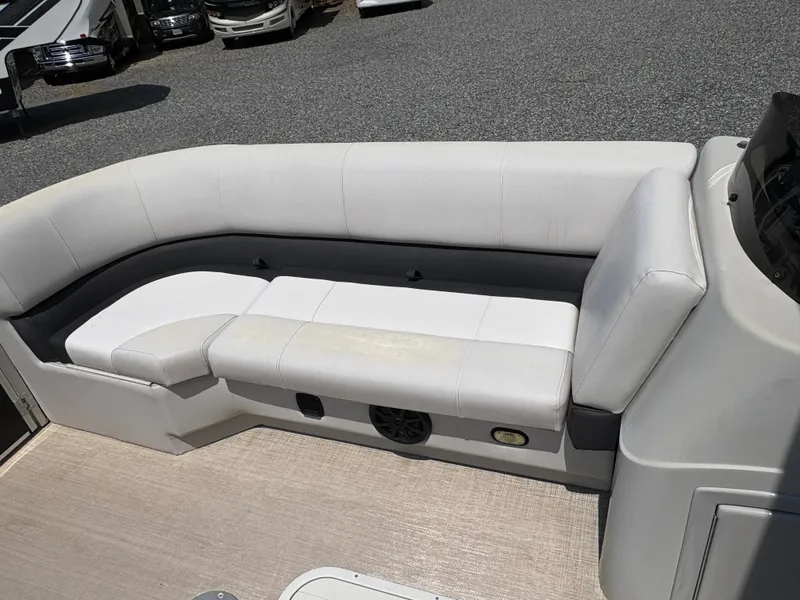 Slide: The Image of 2020 G3 SunCatcher boat interior with white cushioned seating and speaker. - 19