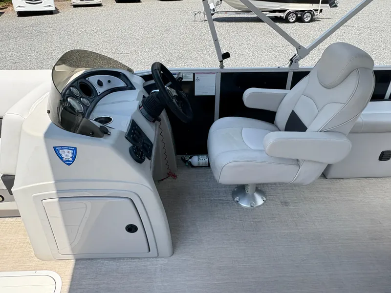 Slide: The Image of 2020 G3 SunCatcher boat interior with steering console and captain's chair. - 20