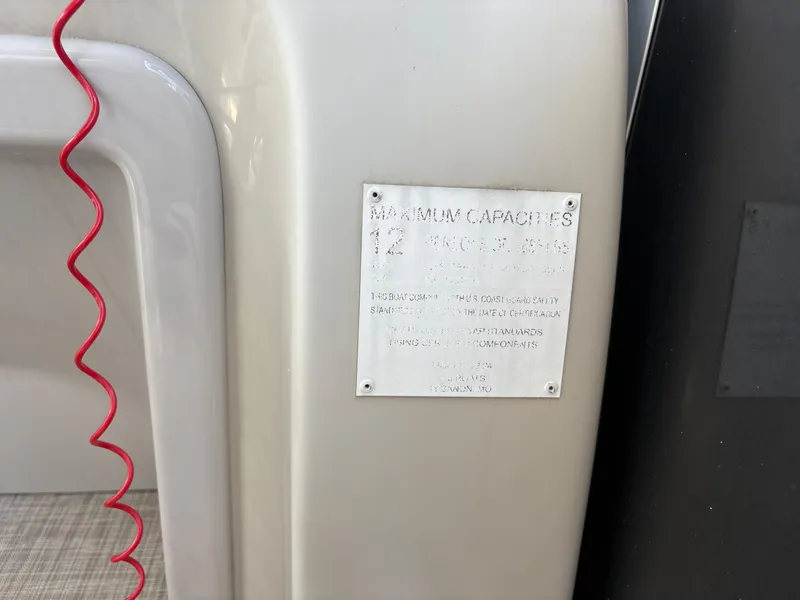 Slide: The Image of 2020 G3 SunCatcher boat capacity plate with red safety cord visible. - 21