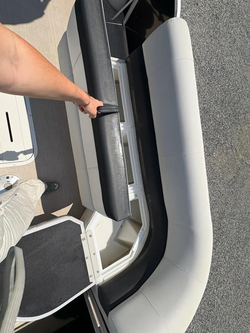 Slide: The Image of 2020 G3 SunCatcher boat interior with black and white seating and storage compartment. - 23