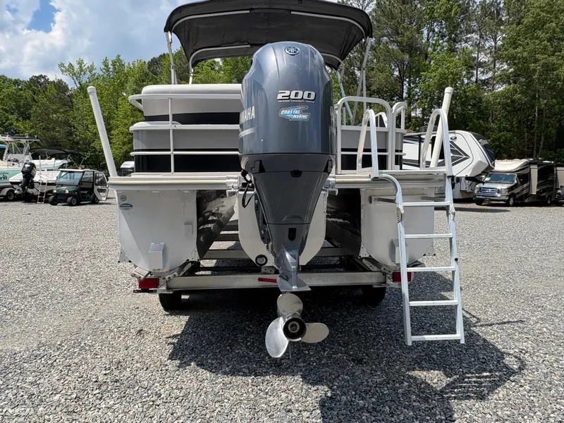 Slide: The Image of 2020 G3 SunCatcher boat with Yamaha 200 engine, parked on gravel lot. - 3