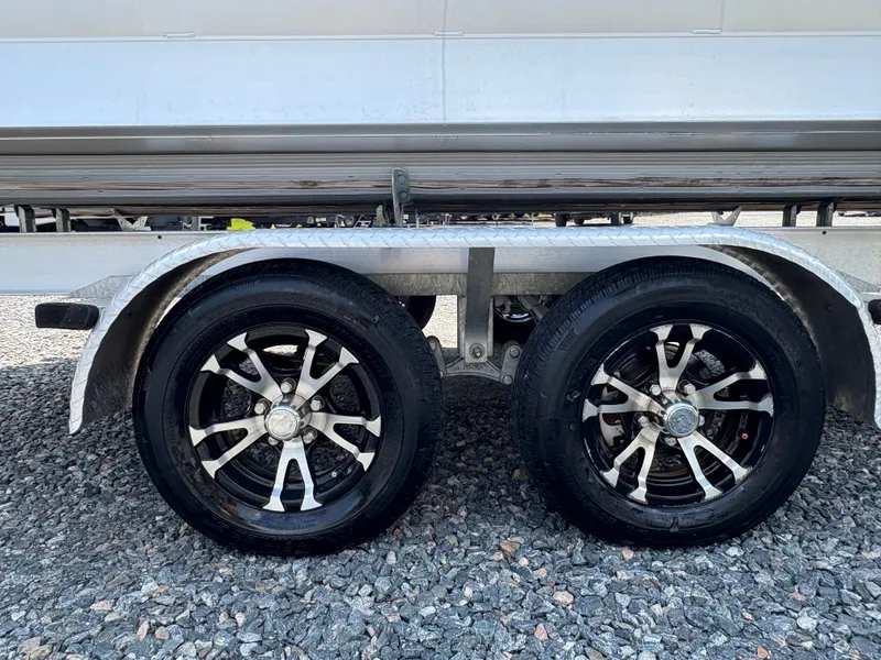 Slide: The Image of 2020 G3 SunCatcher trailer wheels on gravel surface, featuring sleek black and silver rims. - 8