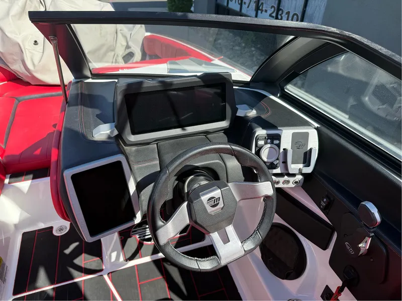 Slide: The Image of 2023 Malibu Wakesetter 23 MXZ dashboard with modern controls and sleek design. - 10